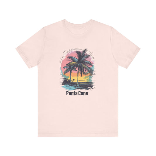 A pink T-shirt with a vibrant color design featuring palm trees and the text 'Punta Cana' on the front.