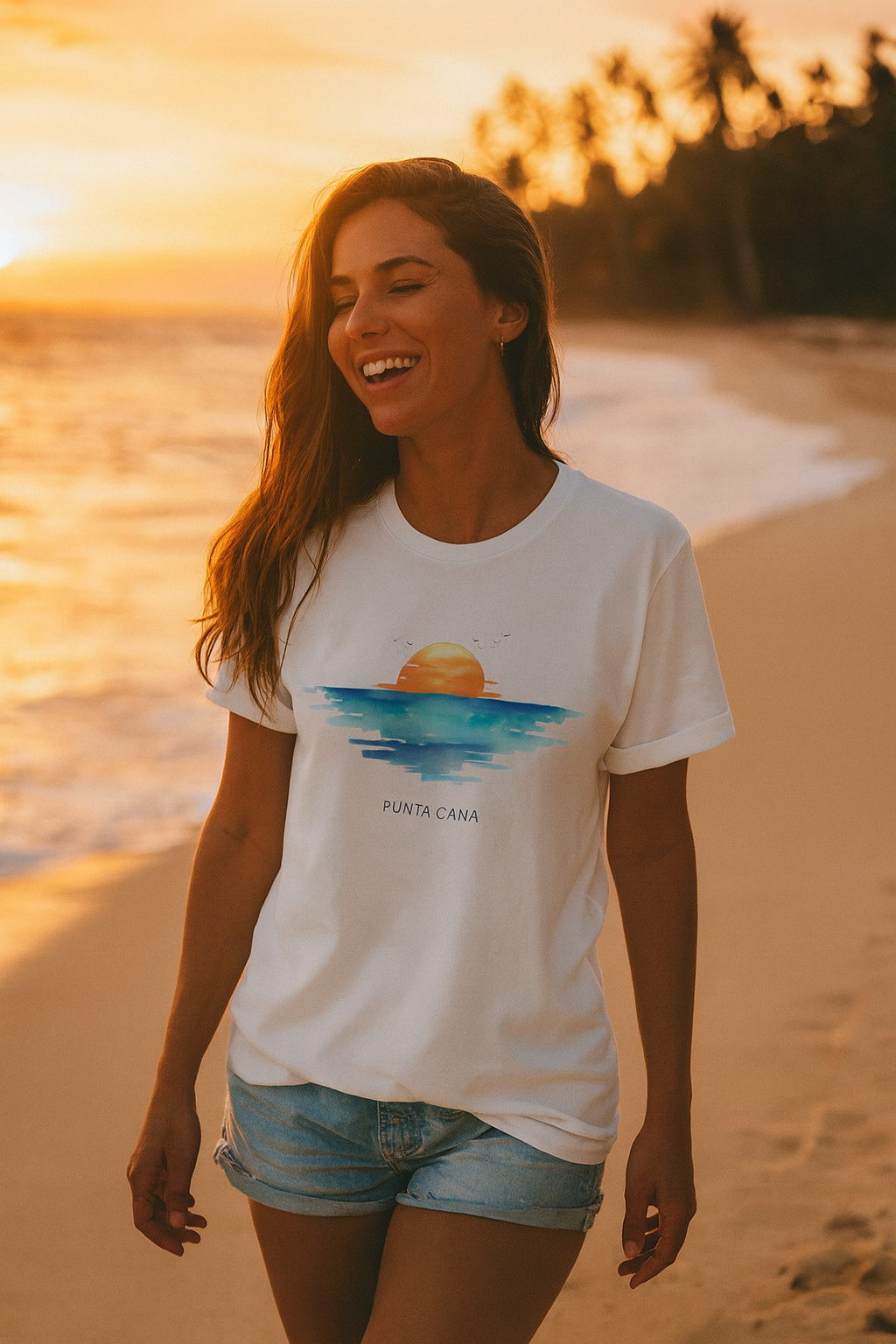 Woman wearing a white t-shirt with a punta cana beach design on a beach at sunset